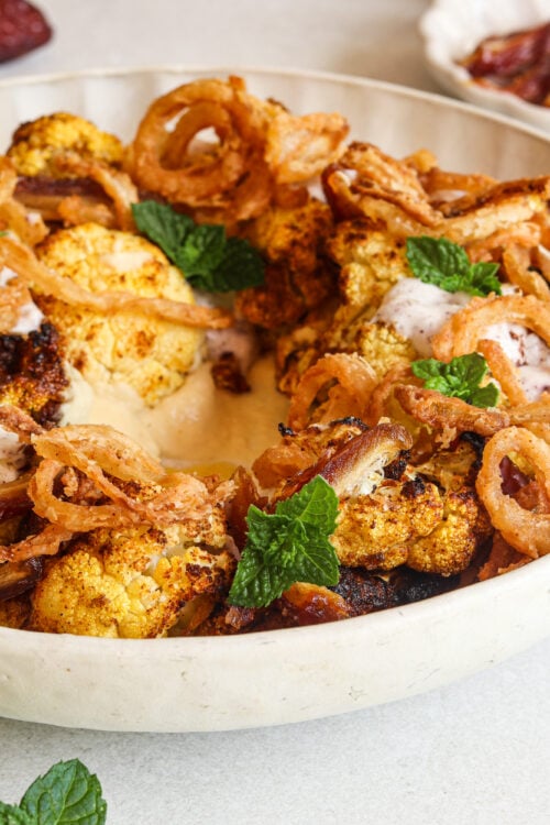 Moroccan-spiced cauliflower salad with hummus, dates, and a coconut yogurt dressing